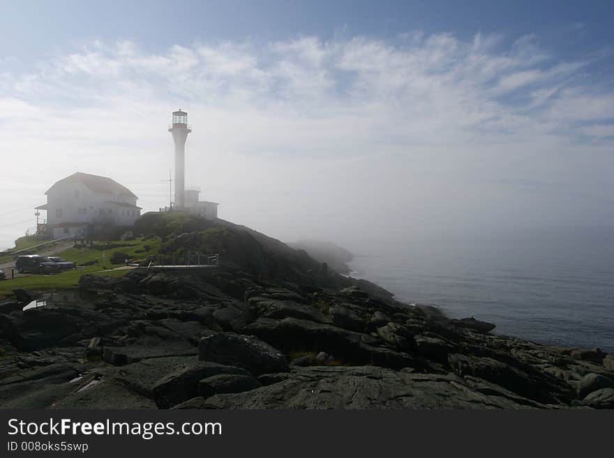 Lighthouse on top of a hill in the fog of a fall morning. Lighthouse on top of a hill in the fog of a fall morning