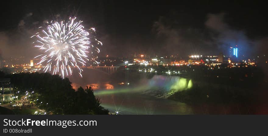 Niagara Falls, Canada a view of American Falls fireworks with a drift of smoke, and green Illuminations. Niagara Falls, Canada a view of American Falls fireworks with a drift of smoke, and green Illuminations