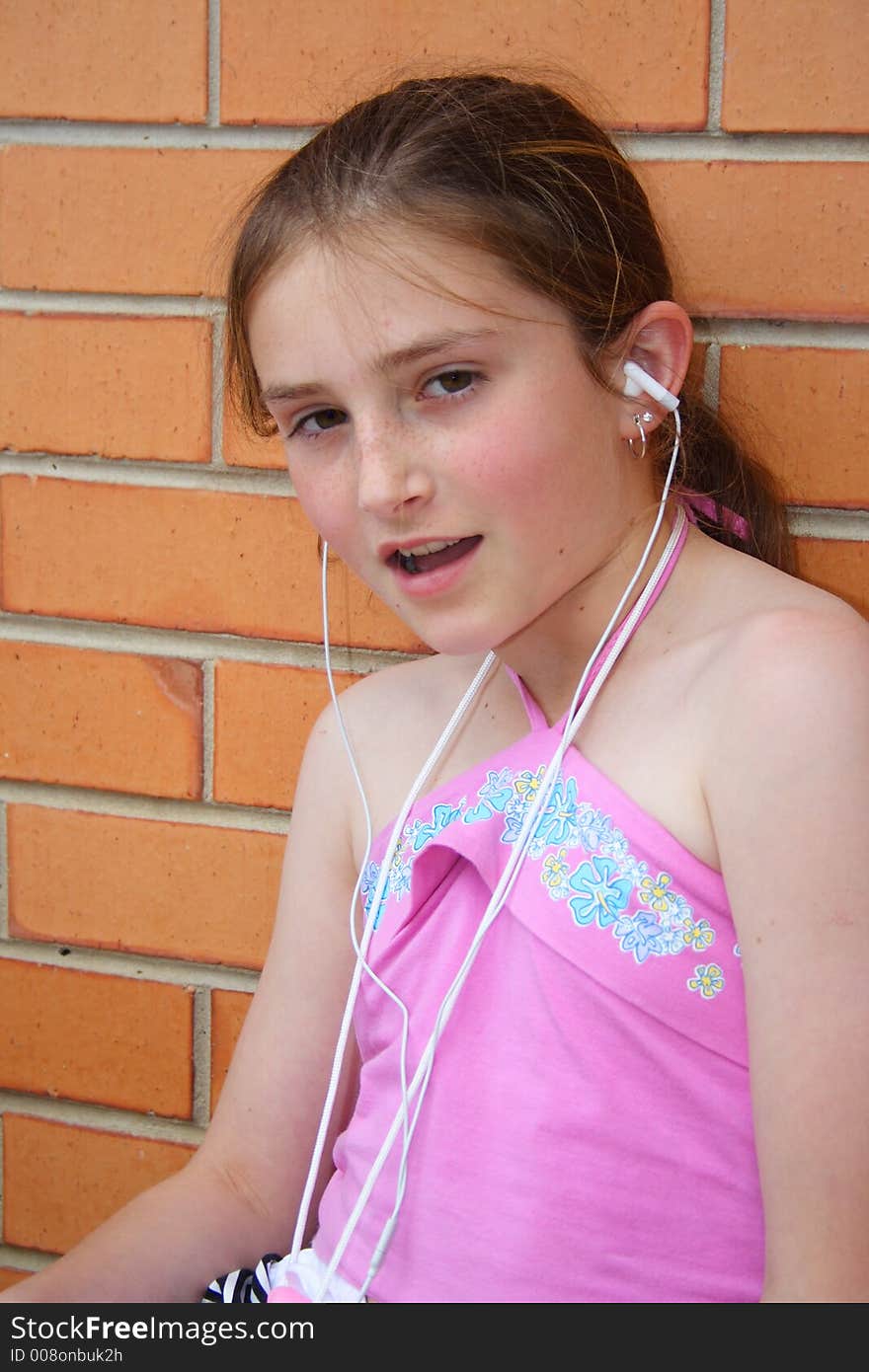 Beautiful girl listening and singing to music player