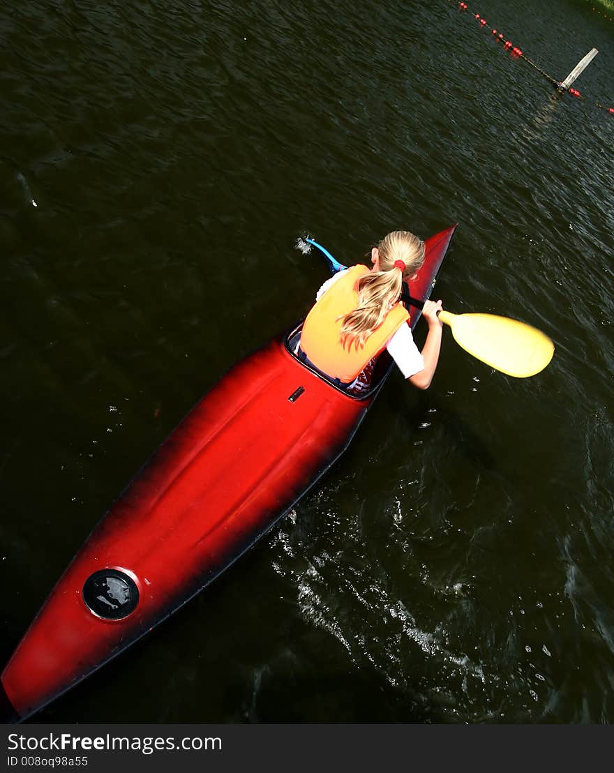 A lake in denmark with a blond girl on a kayak. A lake in denmark with a blond girl on a kayak