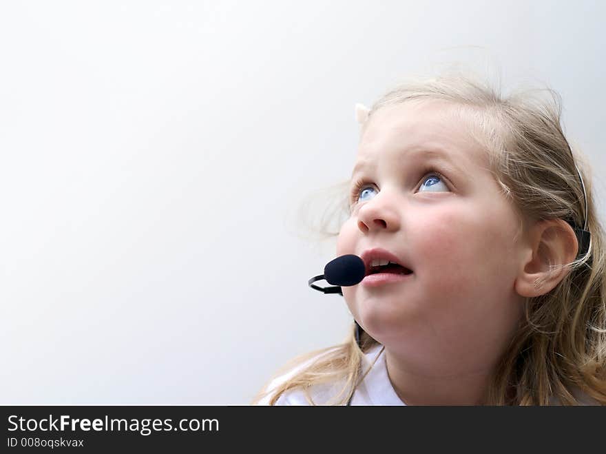 Young girl isolated on white with phone headset. Young girl isolated on white with phone headset