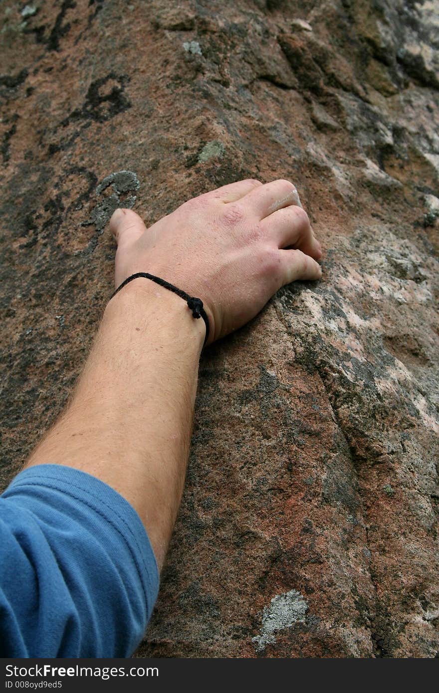 Detail of rock climber's hand on stone. Detail of rock climber's hand on stone