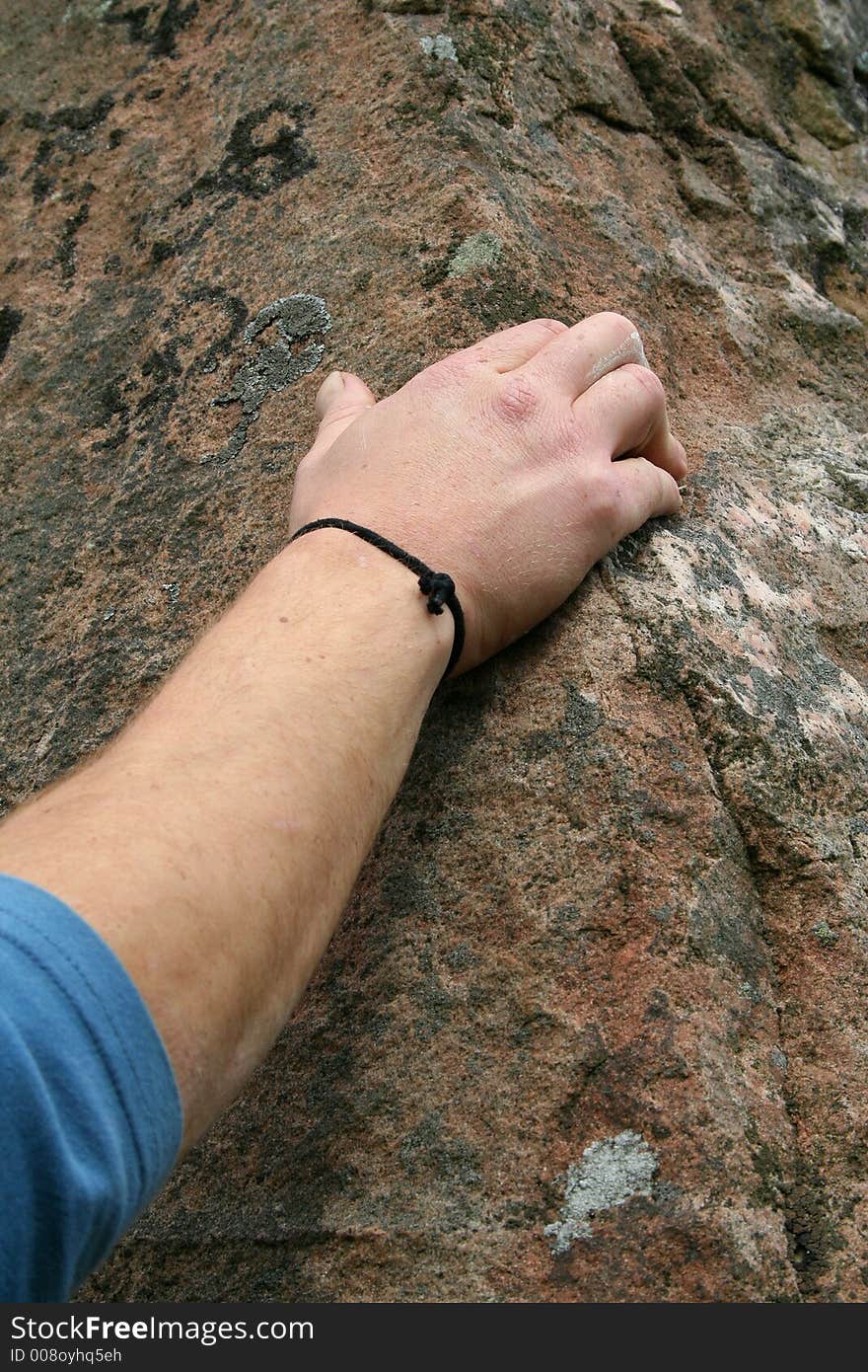 Detail of rock climber's hand on stone. Detail of rock climber's hand on stone