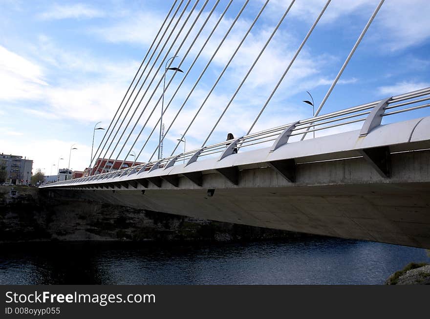 Detail of modern bridge with bright sky above. Detail of modern bridge with bright sky above