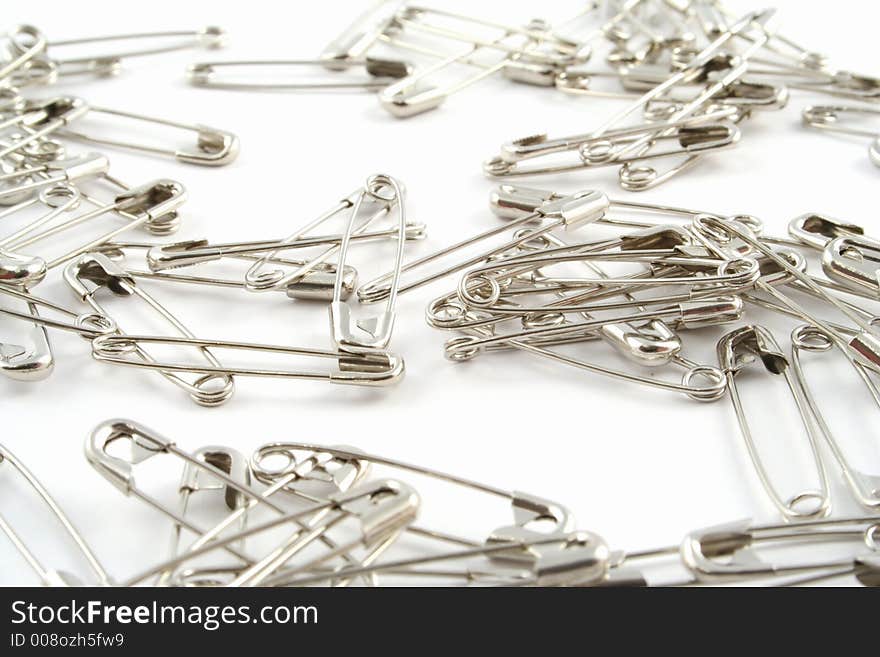 Safety pins on a white background