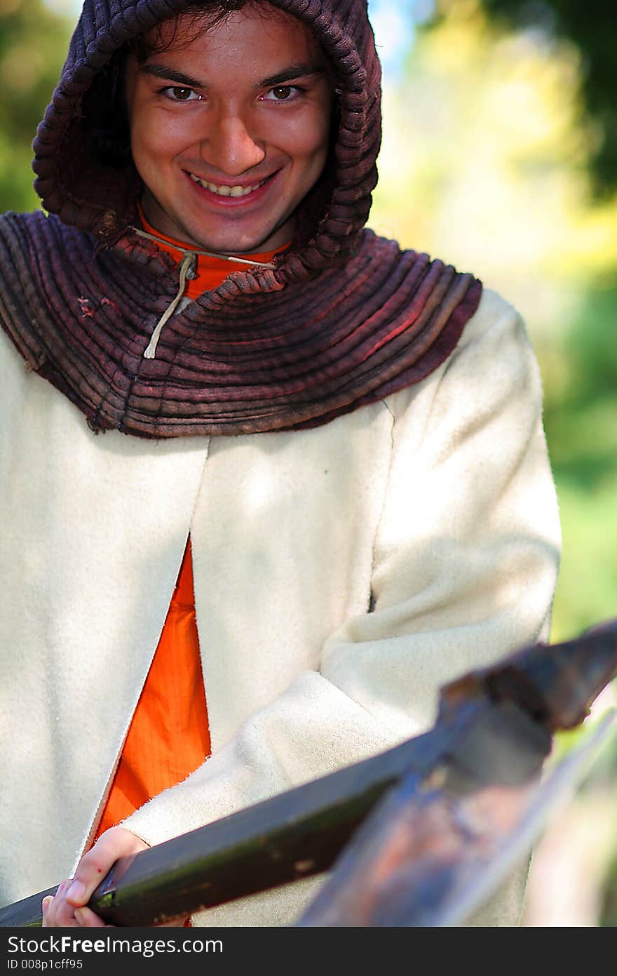 Medieval killer with big tomahawk on the wood chump halloween party. Medieval killer with big tomahawk on the wood chump halloween party