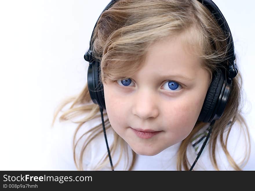 Young girl isolated on white wearing headphones. Young girl isolated on white wearing headphones