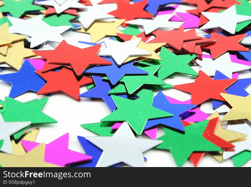 Silver and Gold conefetti stars on a white background. Silver and Gold conefetti stars on a white background