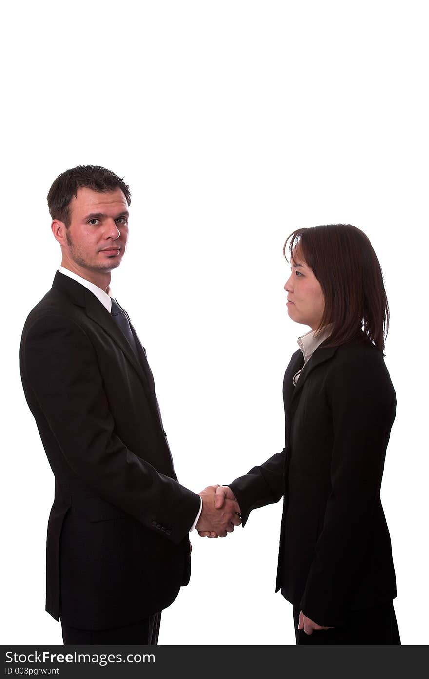 Young asian and american co-workers shaking hands. Young asian and american co-workers shaking hands