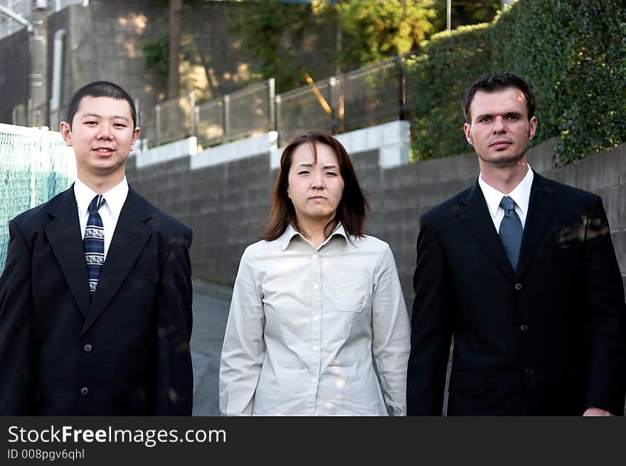 American and asian business people walking on the street. American and asian business people walking on the street