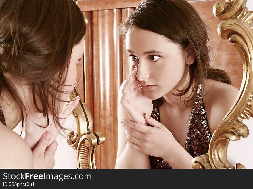 Auburn-haired girl, young woman in front of a mirror. Auburn-haired girl, young woman in front of a mirror