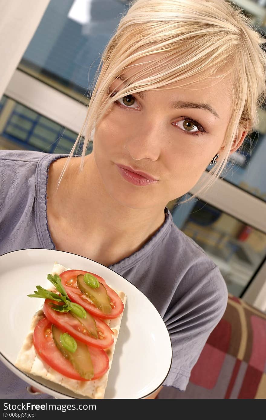 Woman eating a tomato sandwich