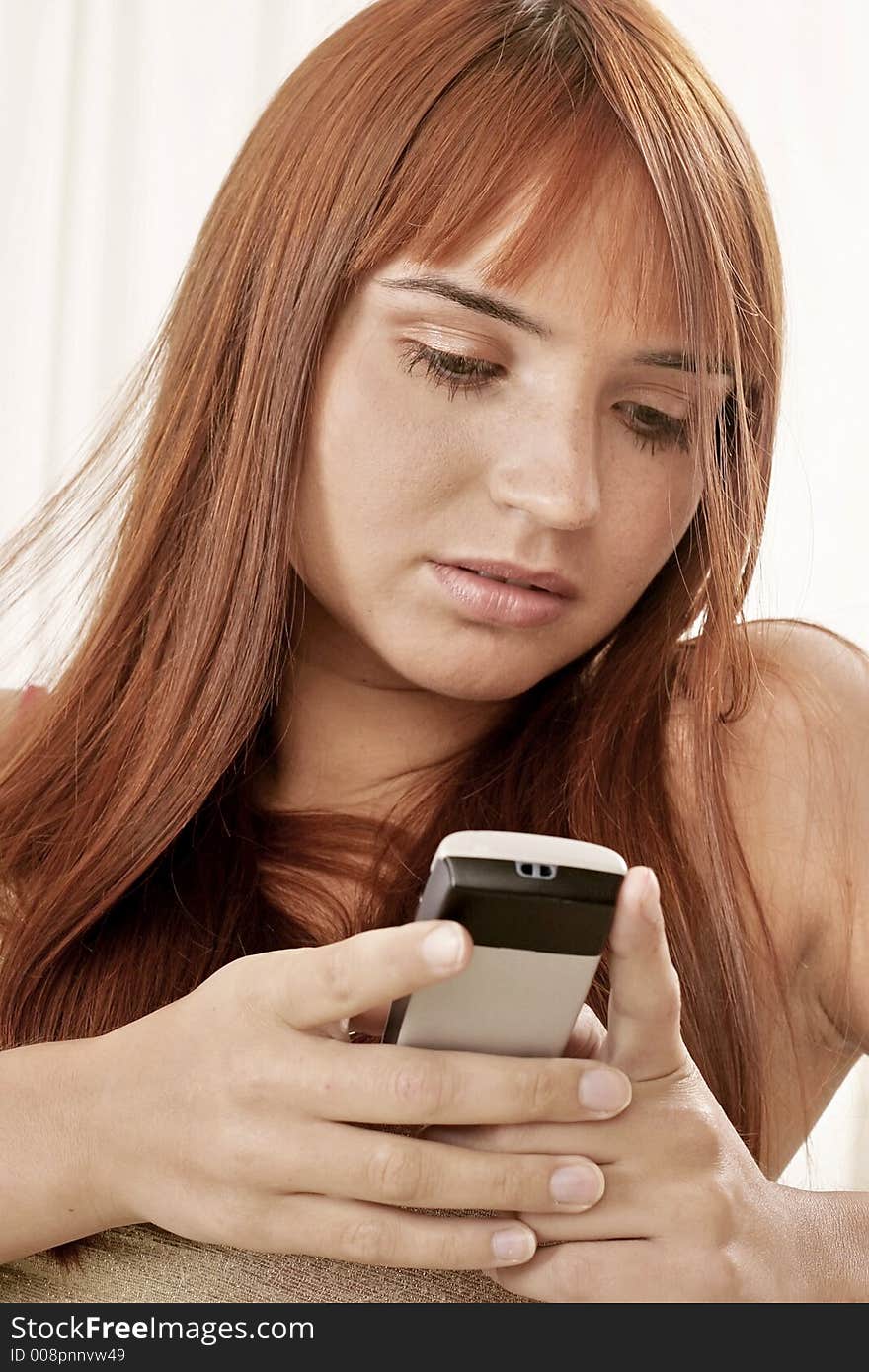 Red-haired young girl, woman with a phone