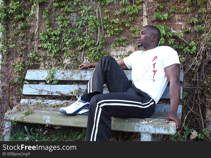 Muscular Model in white shirt sitting on bench