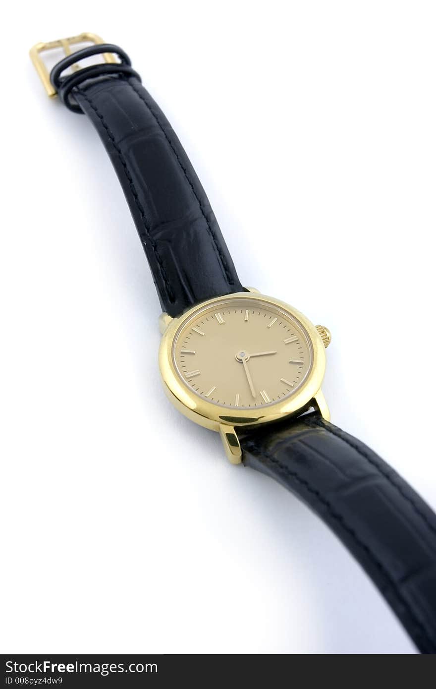 A female golden wrist watch with leather wristlet.