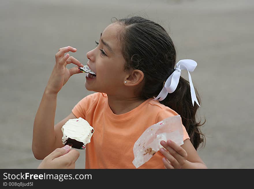 Little girl enjoying a vanilla ice cream bar. Little girl enjoying a vanilla ice cream bar