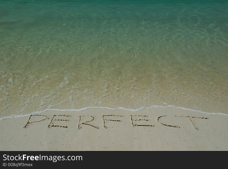 Tropical Sandy Beach With Perfect Inscription on Sand. Closeup.