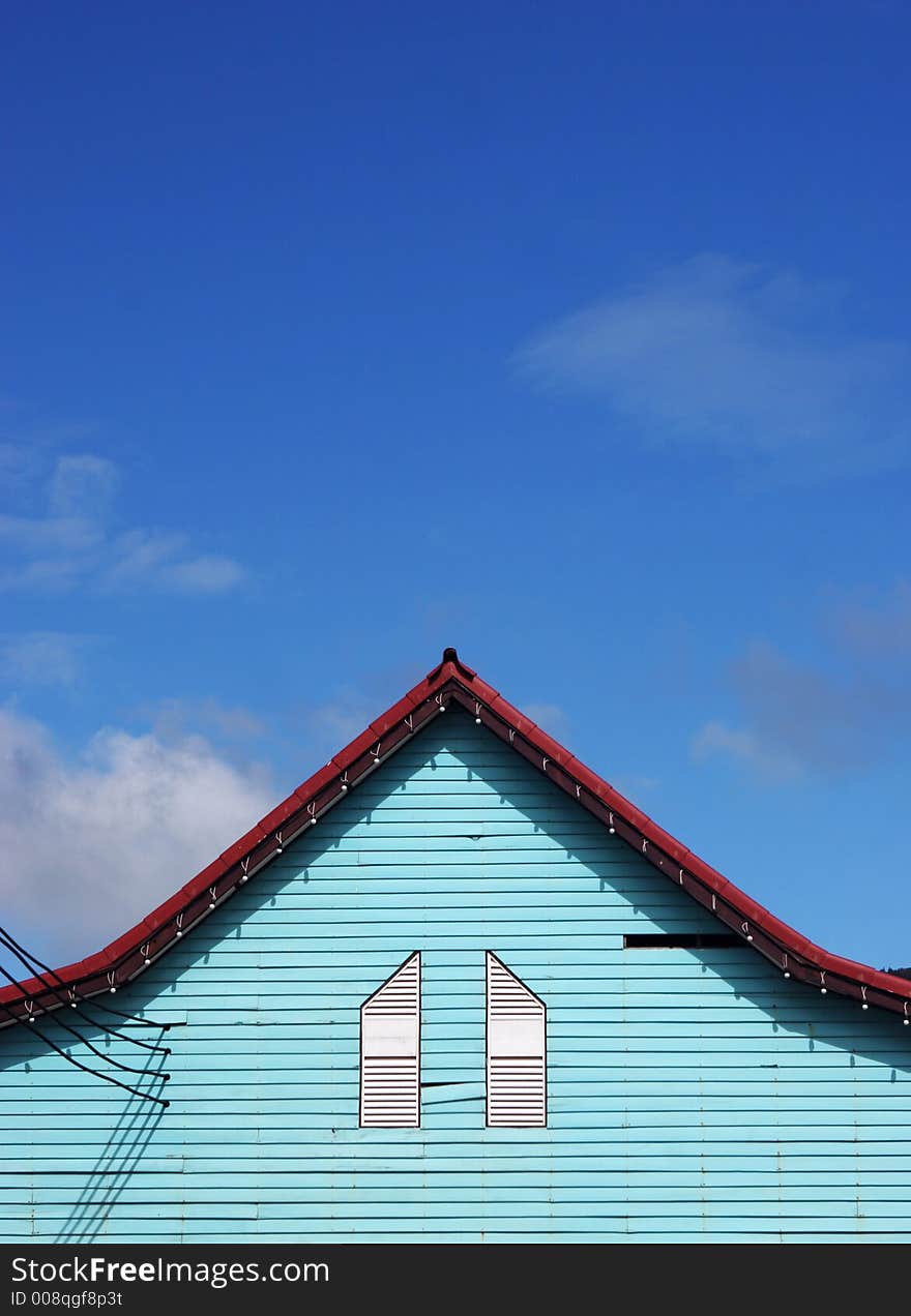 Bright green house against a deep blue sky. Bright green house against a deep blue sky