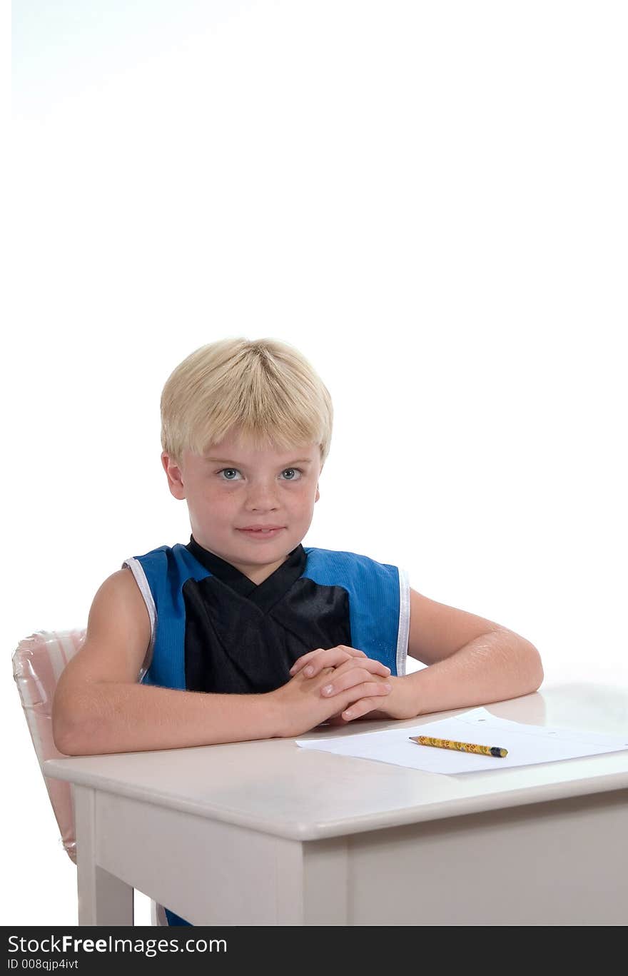 Young male student ready for assignment sitting at desk. Young male student ready for assignment sitting at desk