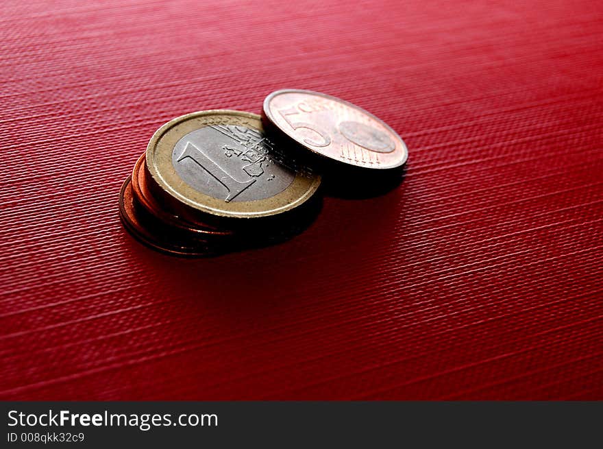 Euro coins on red surface. Euro coins on red surface