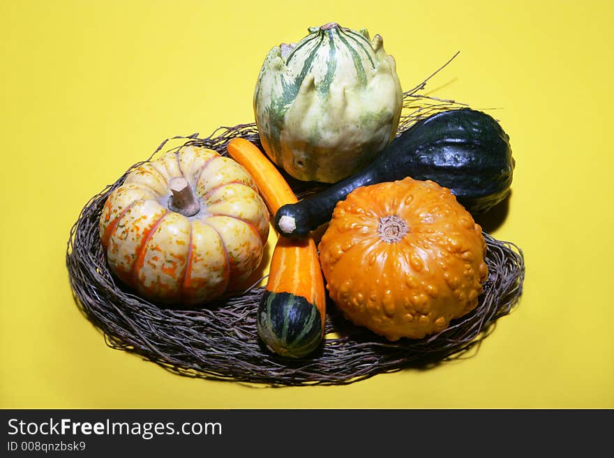 Some gourds arranged with willow branches on a yellow background. Some gourds arranged with willow branches on a yellow background.