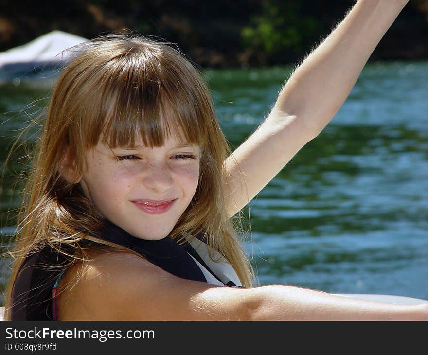 Child holding flag for skier at the lake. Child holding flag for skier at the lake.