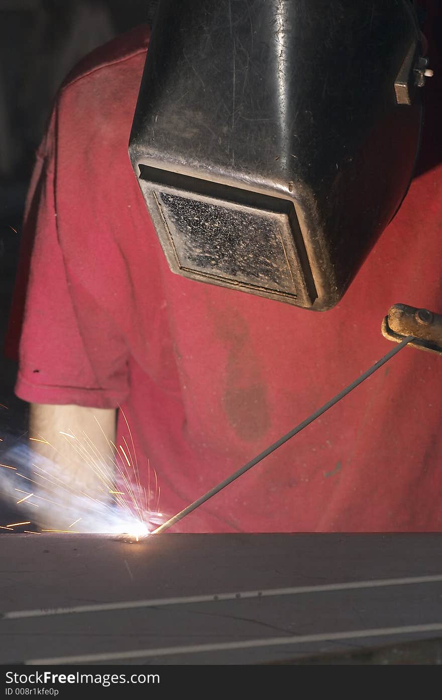 Close view of welder with red shirt. Close view of welder with red shirt