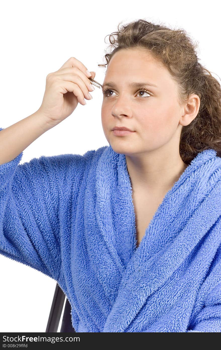 Isolated on white young woman dressed blue bathrobe using tweezer