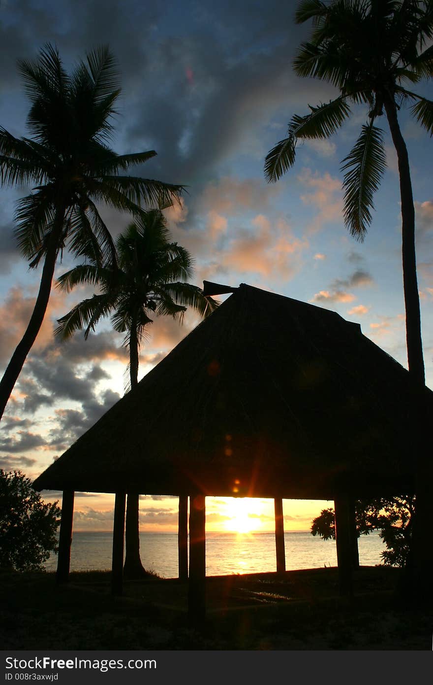 Sunset thru a hut in the pacific. Sunset thru a hut in the pacific