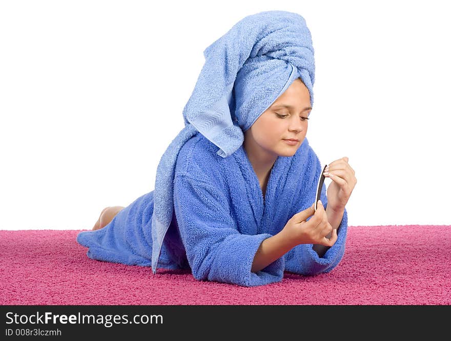 Young woman dressed blue bathrobe and towel filing nails on the pink carpet