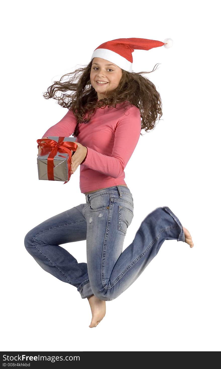 Jumping young female Santa with gift