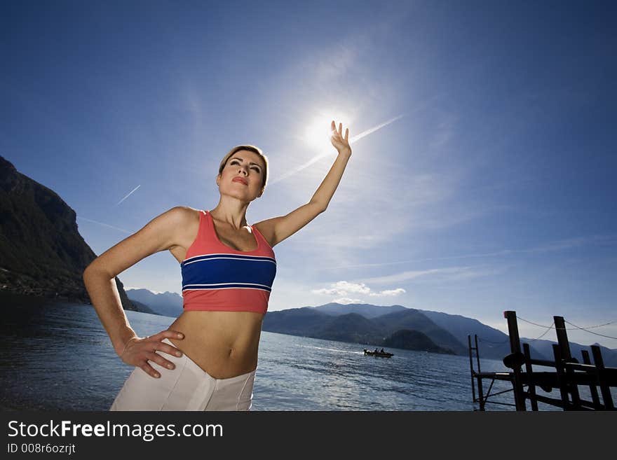 Blond girl doing stretching nearby the lake. Blond girl doing stretching nearby the lake