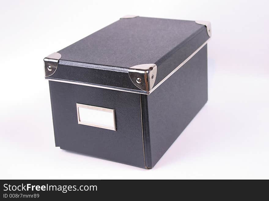 Image of a black box with a white label. Image of a black box with a white label.