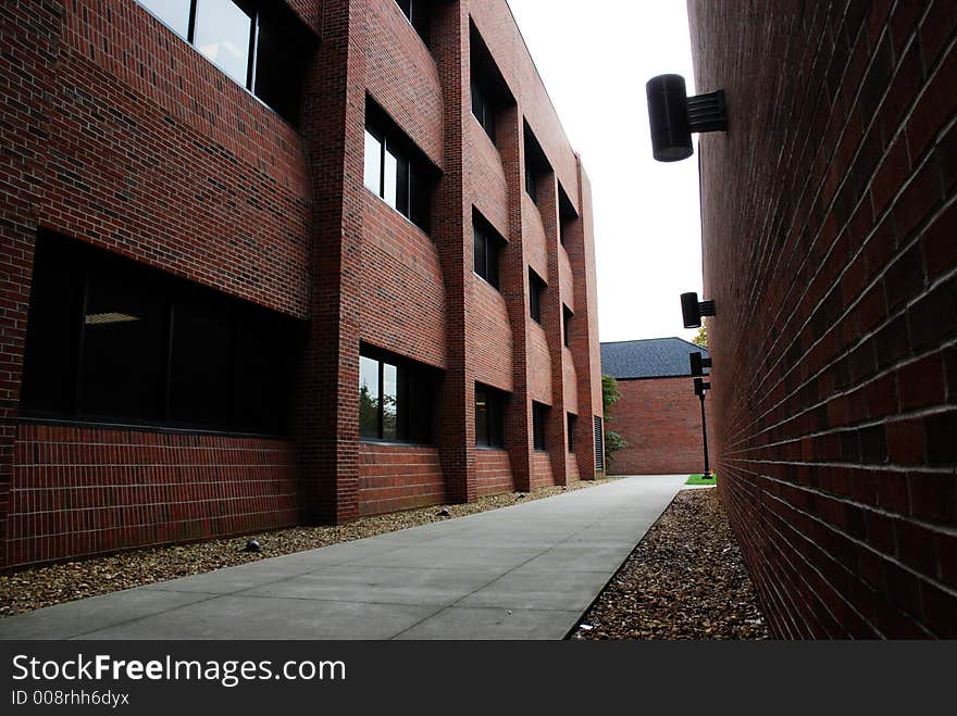 A walk way between two red brick building