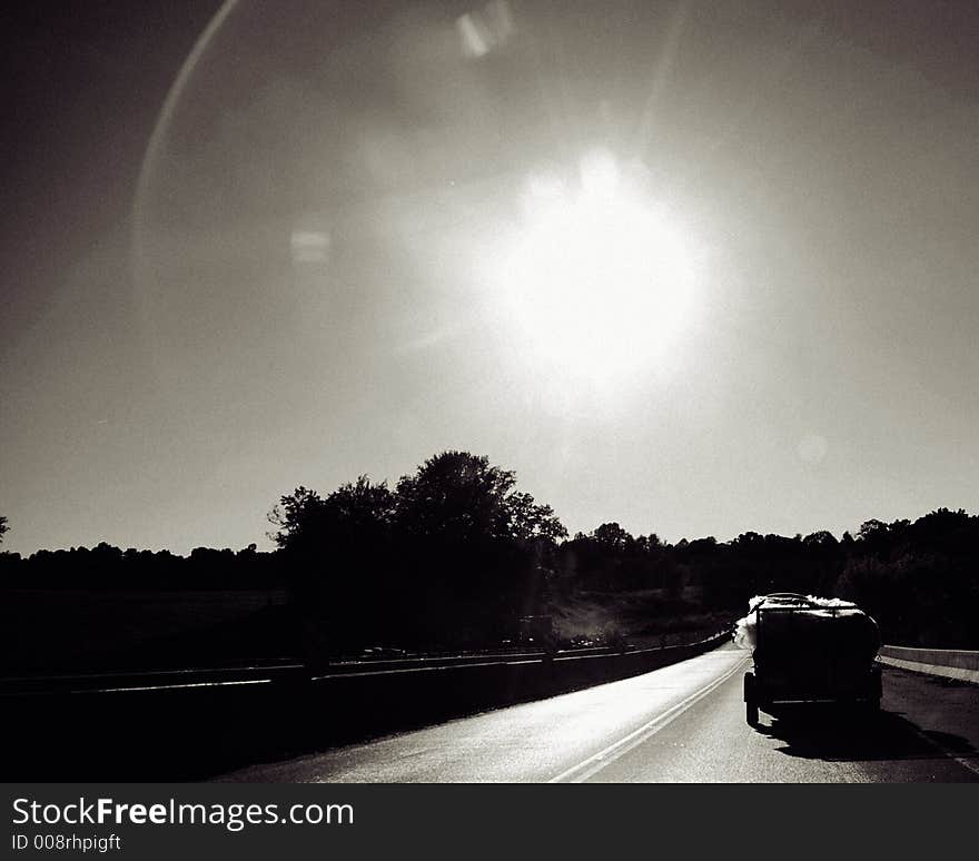 Driving in to the sunset in black and white