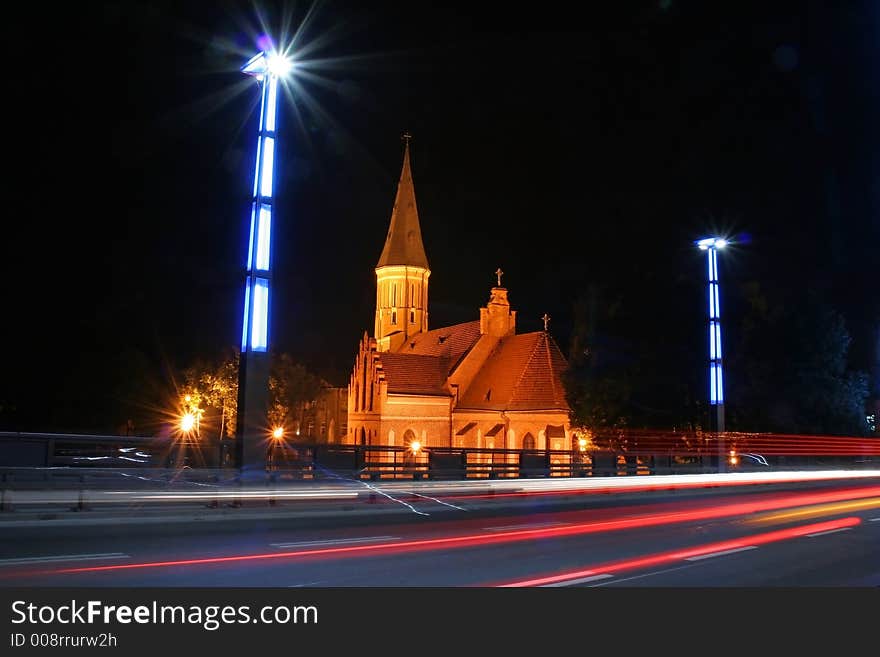 Night scene - traffick on the bridge and church in the background