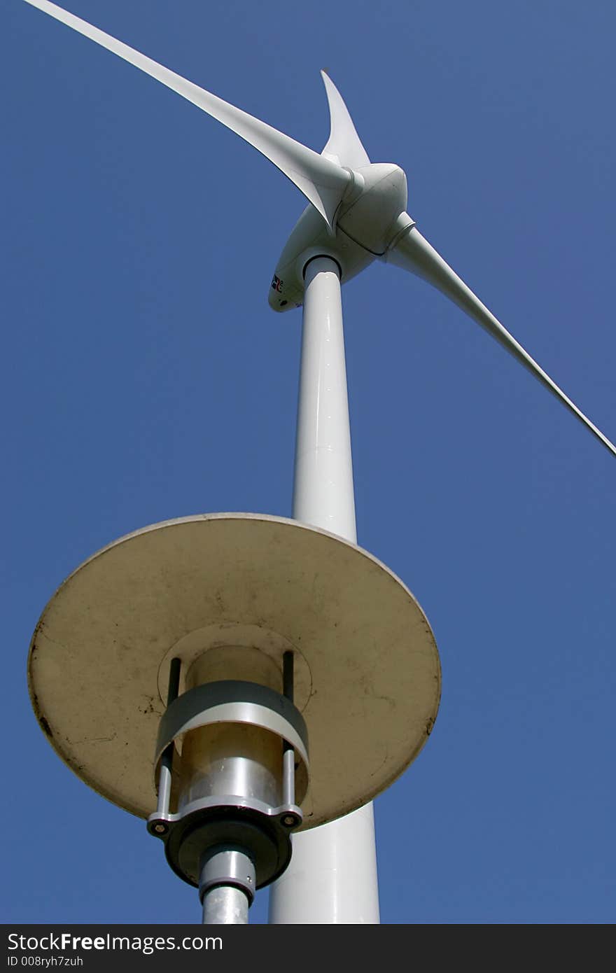 The propeller of a wind turbine photographed from the ground combined with the lamp of a lamp post. The propeller of a wind turbine photographed from the ground combined with the lamp of a lamp post.