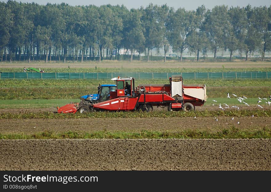 Farmers working on a tractor in the field