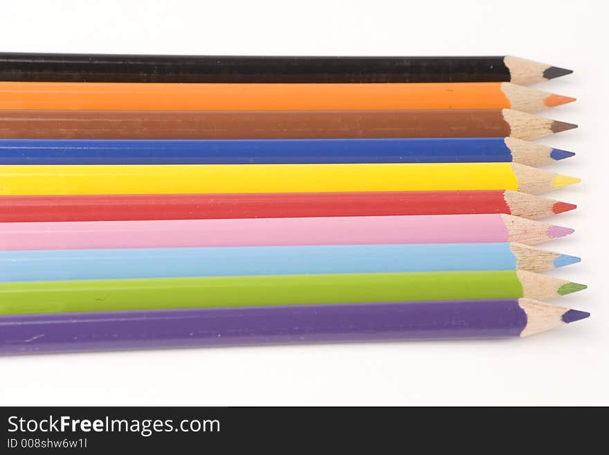 Multiple assorted coloured pencils against a white background. Multiple assorted coloured pencils against a white background.