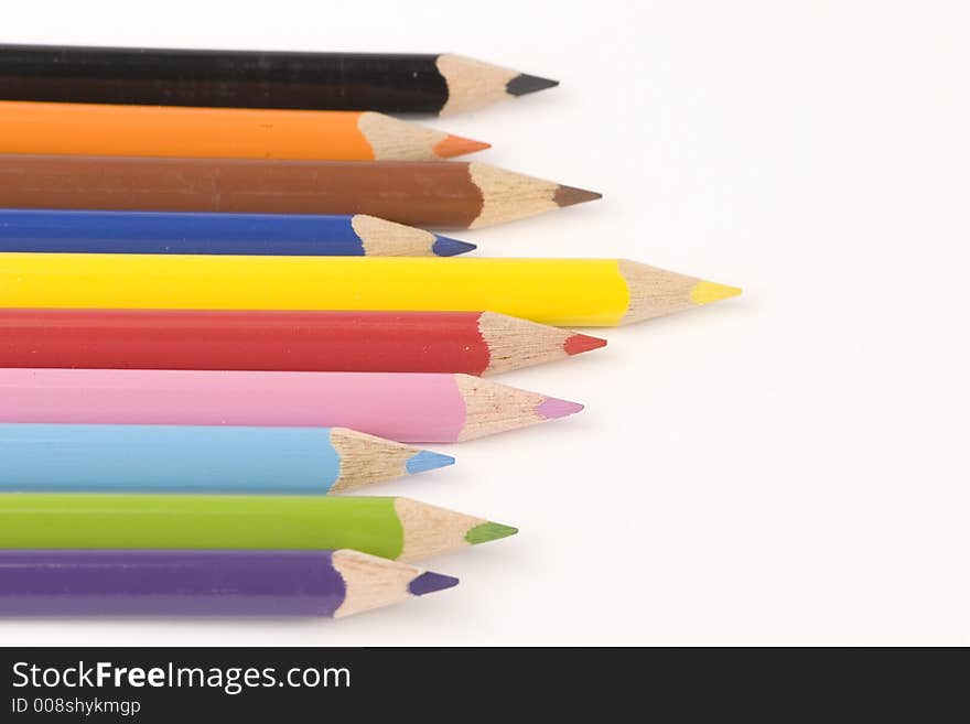 Multiple assorted coloured pencils against a white background. Multiple assorted coloured pencils against a white background.