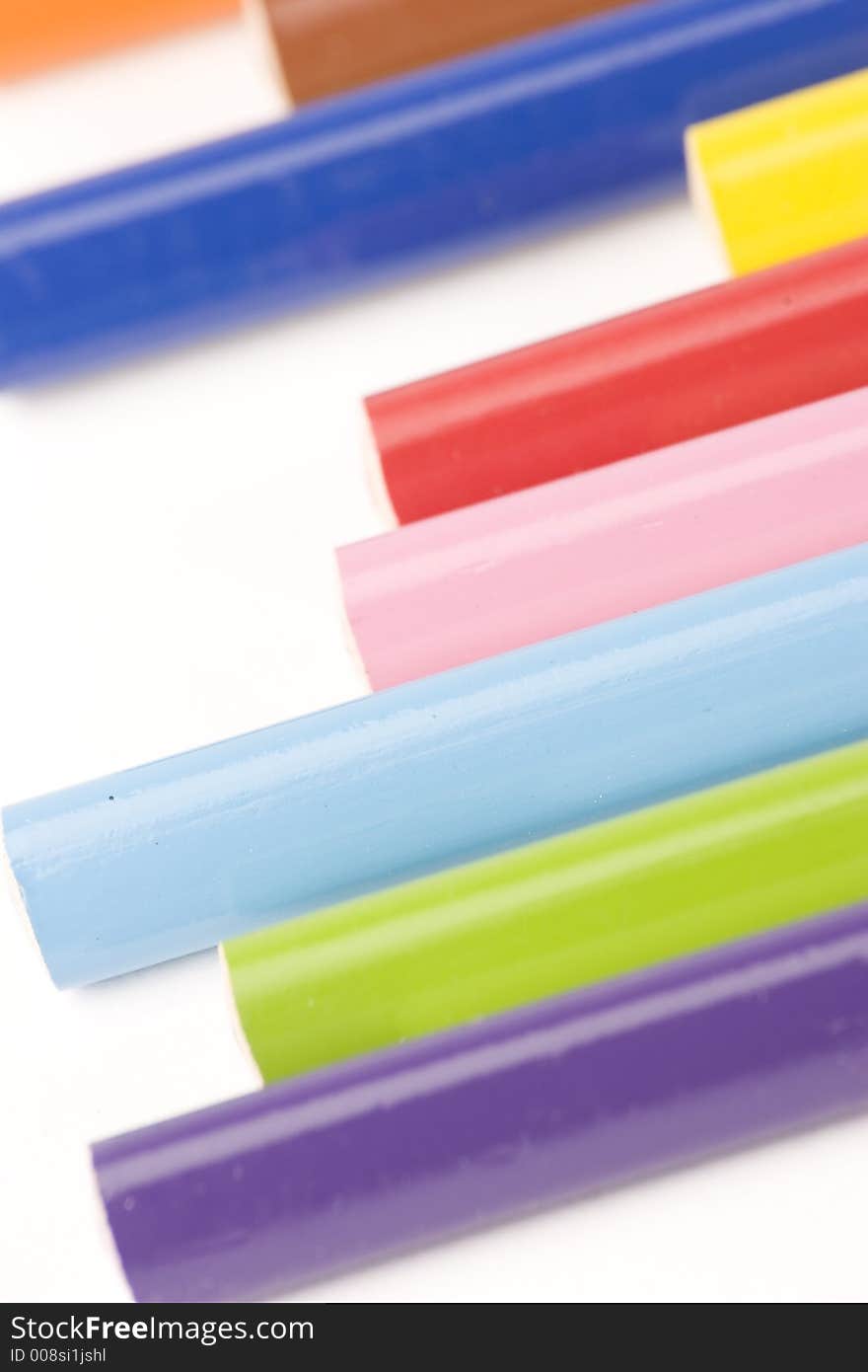 Multiple assorted coloured pencils against a white background. Multiple assorted coloured pencils against a white background.