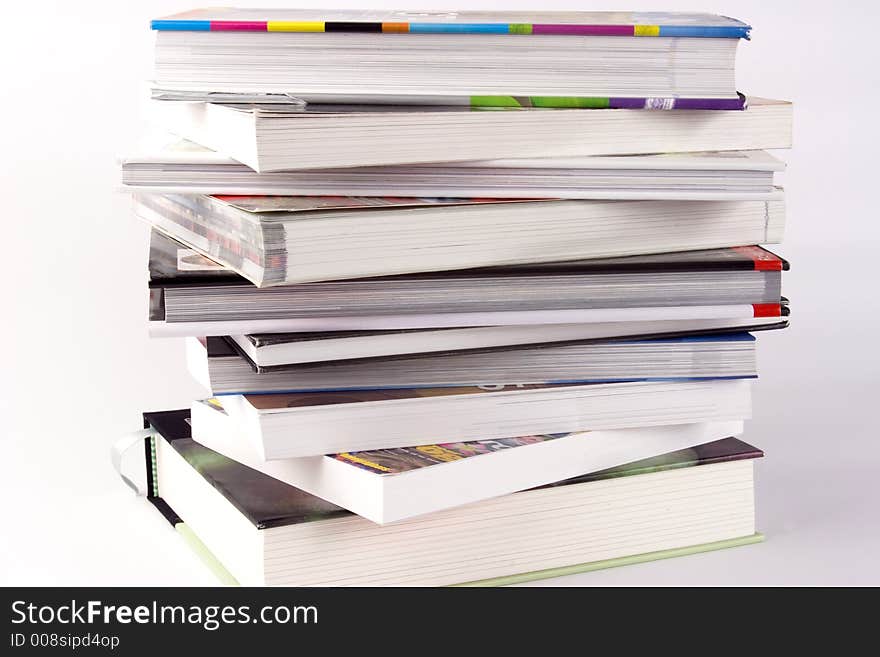 A stack of books against a white background.