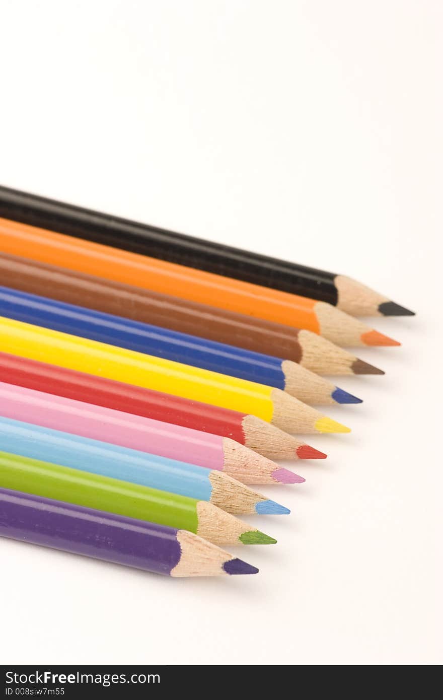 Multiple assorted coloured pencils against a white background. Multiple assorted coloured pencils against a white background.