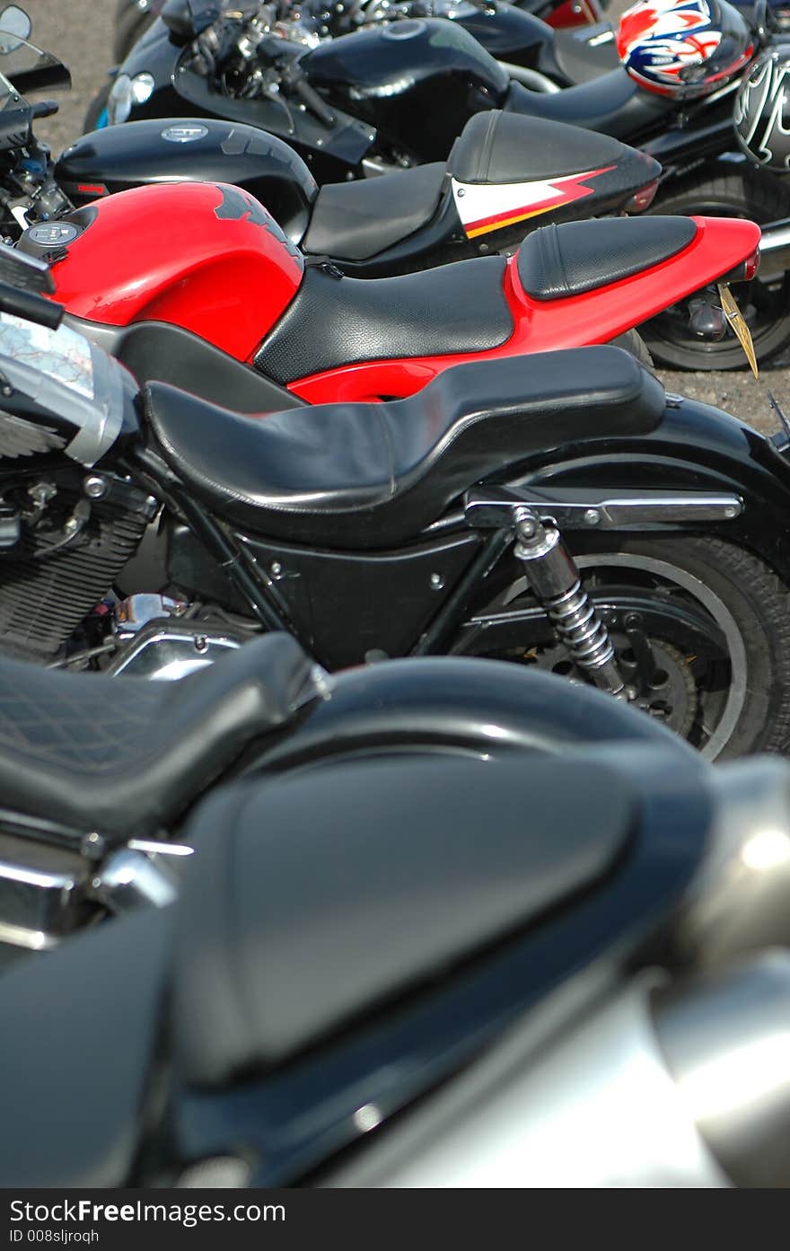 A mass of motorbikes with focal on red machine. A mass of motorbikes with focal on red machine.