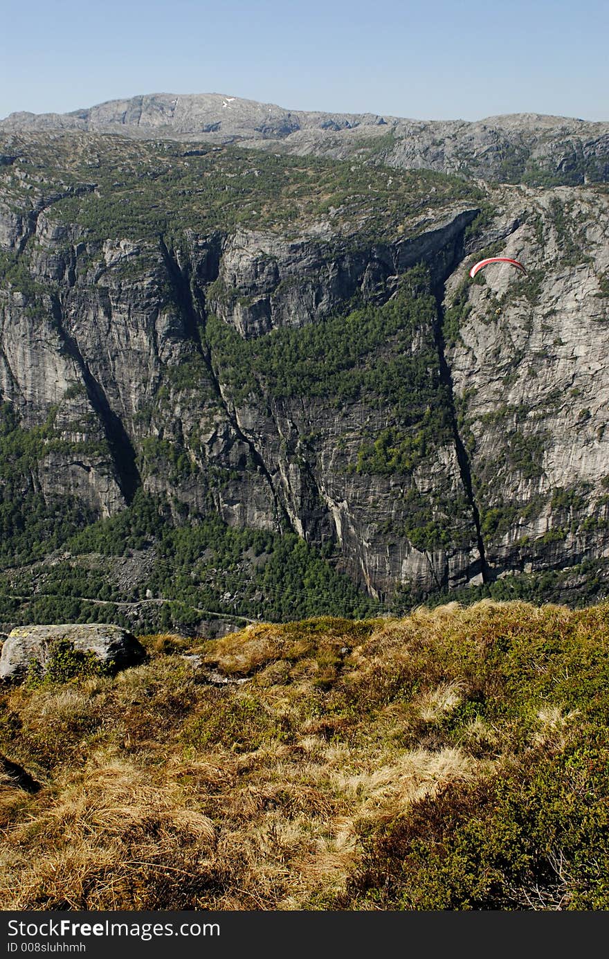 Picture of paraglider flying over Lysefjord in Norway. Picture of paraglider flying over Lysefjord in Norway.