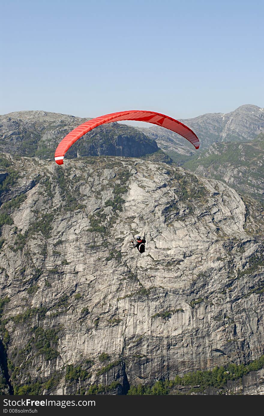 Picture of paraglider flying over Lysefjord in Norway. Picture of paraglider flying over Lysefjord in Norway.