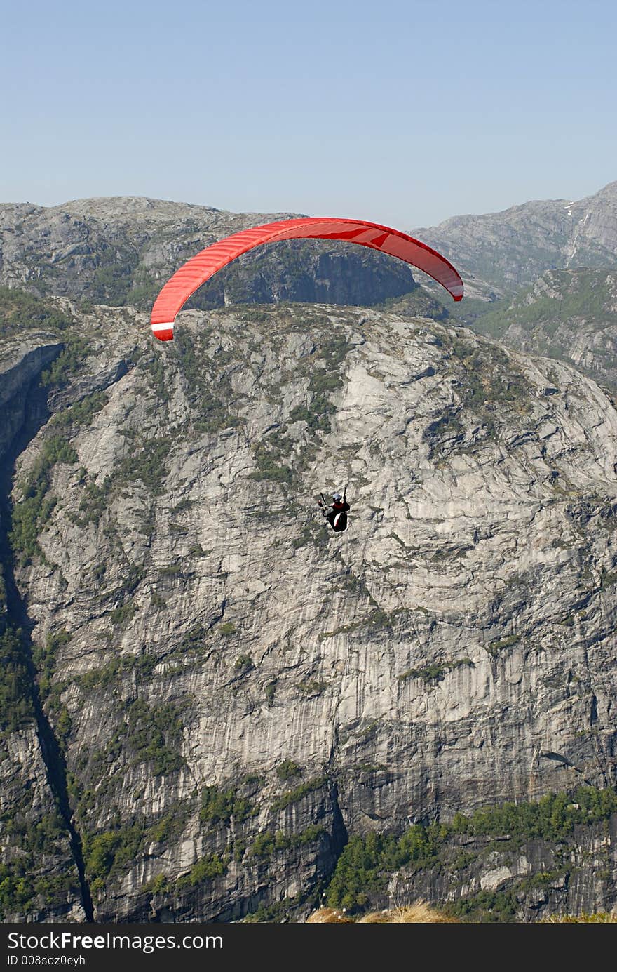 Picture of paraglider flying over Lysefjord in Norway. Picture of paraglider flying over Lysefjord in Norway.