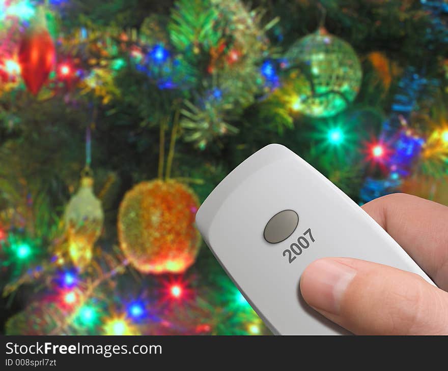 Remote control with one big button 2007 in hand, xmas tree