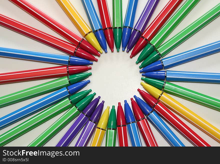Several mlti colored pencils arranged in a circular pattern. Several mlti colored pencils arranged in a circular pattern