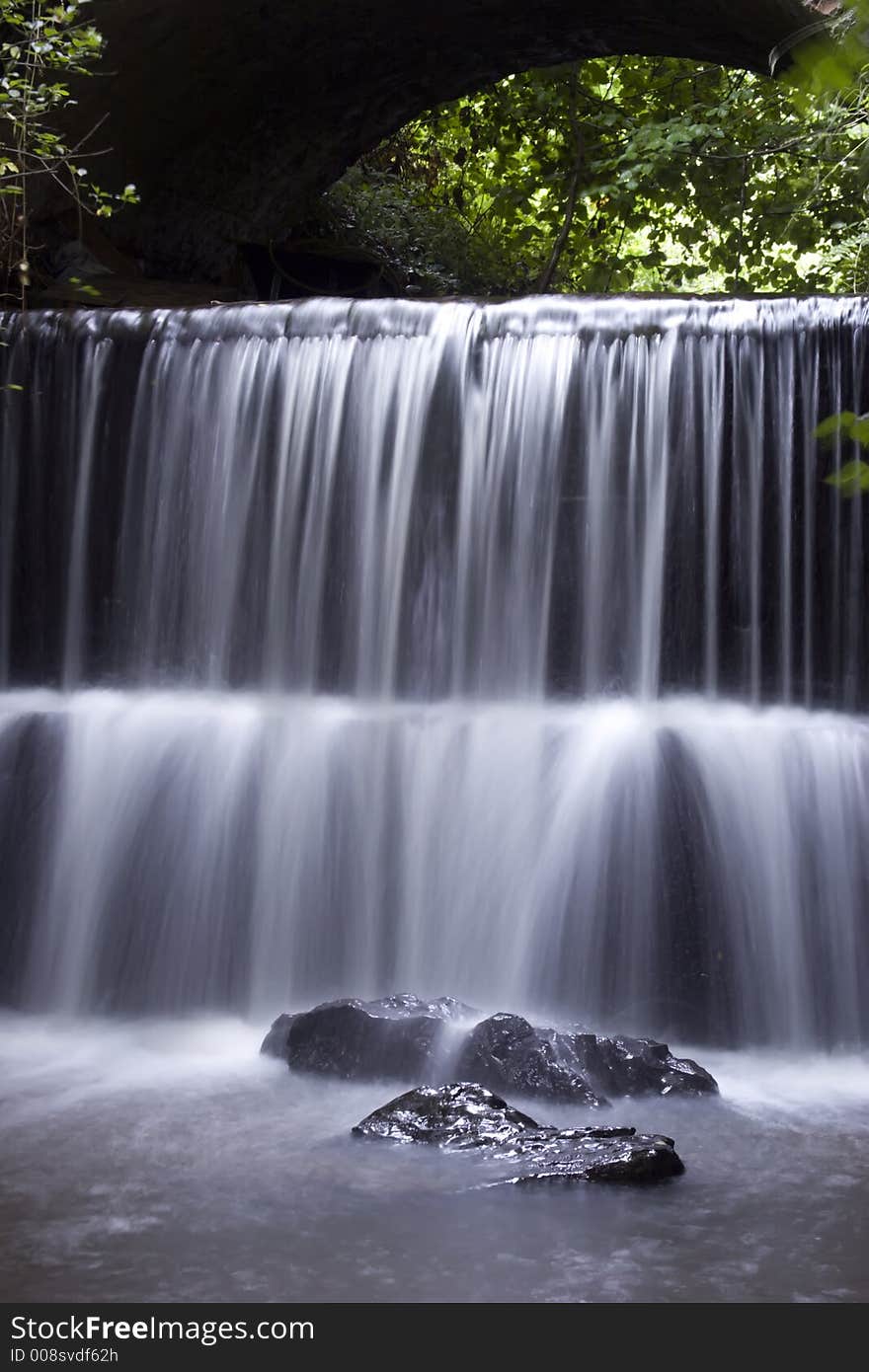 A Waterfall under a Bridge in Honiton, Devon.U.K. A Waterfall under a Bridge in Honiton, Devon.U.K